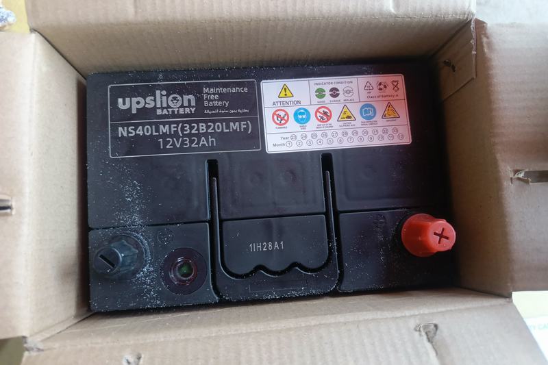 New sealed maintenance-free battery in its box with a date sticker and charge indicator