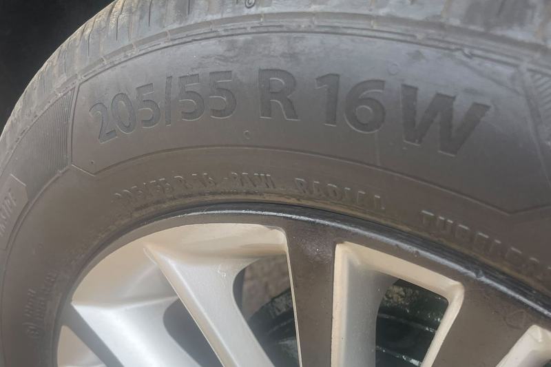 Tyre sidewall on an alloy wheel showing the size marking 205/55 R16