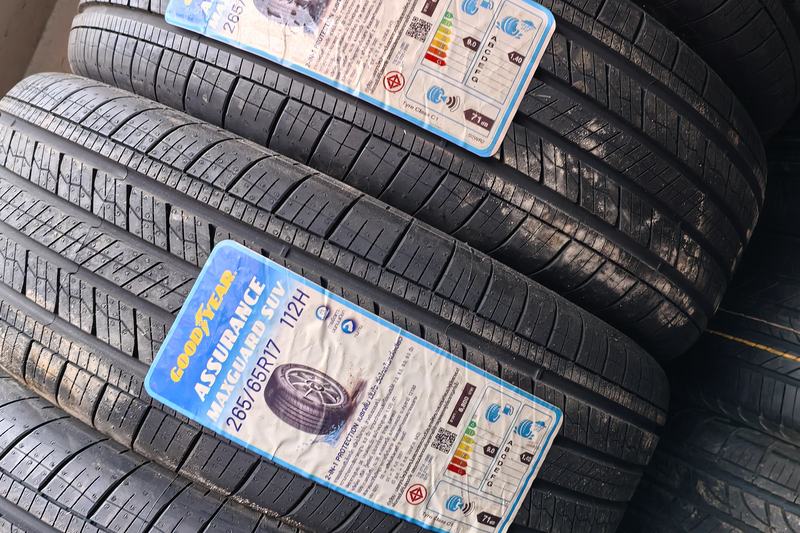 Stack of new Goodyear Assurance MaxGuard SUV tyres with manufacturer labels