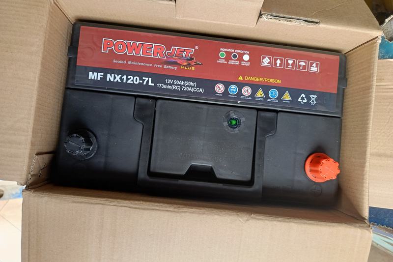 Sealed maintenance-free car battery with a colour charge indicator on the label