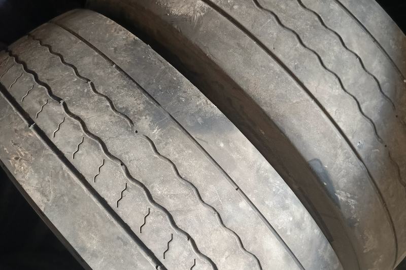 Two worn tyres with very shallow tread grooves