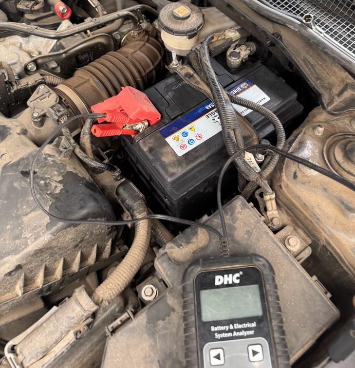 Battery analyzer connected to a car battery to test the battery and charging system